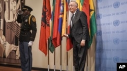 A United Nations police officer salutes as Ecuador's U.N. Ambassador Hernán Pérez Loose, right, installs his country's flag during a ceremony for five newly-elected non-permanent members to serve on the United Nations Security Council, at U.N. headquarters on Jan. 3, 2023. 