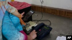 A Kashmiri woman makes a call to a relative after landline phones were restored in Srinagar, Indian controlled Kashmir, Sept. 5, 2019.