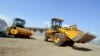 Des tracteurs travaillent à la rénovation de la zone portuaire dans le quartier Mpila Est de Brazzaville le 28 mars 2013. (Photo JUNIOR D.KANNAH / AFP)