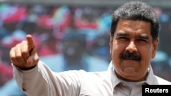 Venezuela's President Nicolas Maduro greets supporters during a campaign rally in Charallave, Venezuela, May 15, 2018. 