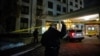 A police officer walks under the police line after a fatal mass shooting at a condominium building in the Toronto suburb of Vaughan, Ontario, Canada Dec. 19, 2022. 