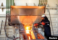 FILE—A worker attends to machinery at a smelter plant at Anglo American Platinum's Unki mine in Shurugwi, Zimbabwe, May 16, 2019.