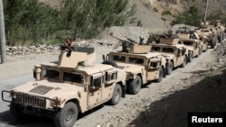 An Afghan commando forces armored convoy leaves toward the front line, at Ghorband district, Parwan province, Afghanistan, June 29, 2021. 