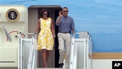 President Barack Obama and first lady Michelle Obama arrive at Cape Cod Coast Guard Station in Bourne, Mass., Aug. 10, 2013.