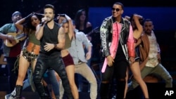 FILE - Luis Fonsi, left, and Daddy Yankee perform during the Latin Billboard Awards in Coral Gables, Fla. 