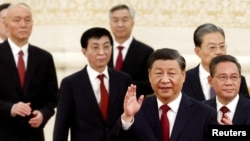 New Politburo Standing Committee members led by President Xi Jinping arrive to meet the media following the 20th National Congress of the Communist Party of China, at the Great Hall of the People in Beijing, Oct. 23, 2022. 