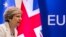 FILE - British Prime Minister Theresa May prepares to address a media conference at an EU summit in Brussels, June 23, 2017. 
