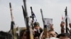 A child holds a toy gun at a Houthi rally supporting Palestinians in the Gaza Strip, in Sanaa, Yemen, on Aug. 30, 2024. The Houthi rebels are suspected of firing two missiles at a container ship in the Gulf of Aden on Aug. 30.