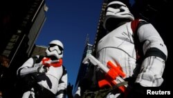 People dressed as Stormtroopers from Star Wars 'Rogue One' walk in Times Square, New York City, Dec. 25, 2016. The next standalone Star Wars movie may be based on the character Obi-Wan Kenobi.