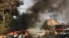 Firefighters douse a car blaze in the southern Israeli city of Ashkelon after a rocket attack from Gaza on October 9, 2023.