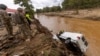 A search and rescue team out of Atlantic Beach, examines a van swept into the river in Swannanoa