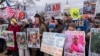 FILE - Demonstrators rally in Washington against U.S. President Donald Trump and Elon Musk as they disrupt the federal government, including dismantling the U.S. Agency for International Development, which administers foreign aid approved by Congress, Feb. 5, 2025. 