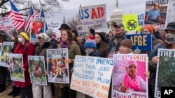 FILE - Demonstrators rally in Washington against U.S. President Donald Trump and Elon Musk as they disrupt the federal government, including dismantling the U.S. Agency for International Development, which administers foreign aid approved by Congress, Feb. 5, 2025. 