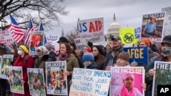 FILE - Demonstrators rally against the Trump administration as it dismantles the U.S. Agency for International Development, which administers foreign aid approved by Congress, on Capitol Hill in Washington, Feb. 5, 2025.