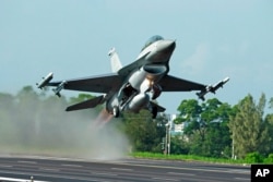 FILE - A Taiwanese Air Force F-16 fighter jet takes off from a closed section of highway during the annual Han Kuang military exercises in Chiayi, central Taiwan, Sept. 16, 2014.