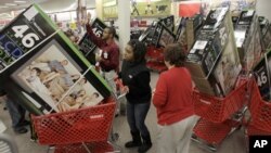 File — Early bird shoppers snatch up flat screen televisions at the Target store in Mayfield Hts., Ohio, on Black Friday.