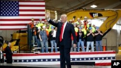 President Donald Trump waves as he is introduced to speak at Local 18 Richfield Training Facility, March 29, 2018, in Richfield, Ohio. 