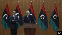 Libya's Prime Minister designate Abdurrahim El-Keib (R) and Abdul Hafez Goga, spokesman for the NTC attend a news conference in Tripoli, November 22, 2011.