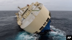 Visitors on boats enjoy Someiyoshino cherry blossoms at Chitorigafuchi Imperial Palace moat in Tokyo.