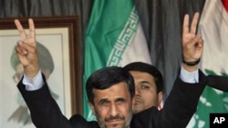 Iranian President Mahmoud Ahmadinejad flashes a V sign during a rally organized by Hezbollah in the southern border town of Bint Jbeil, Lebanon, 14 Oct 2010