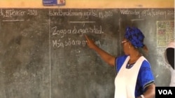 A teacher writes in Ewondo, one of Cameroon's national languages, at a school in Yaounde, Feb. 21, 2020. (Moki Edwin Kindzeka/VOA)