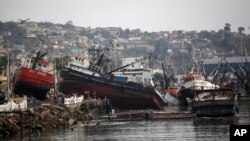 FILE - Boats lifted by an earthquake-triggered tsunami sit on a dock, in Coquimbo, Chile, Sept. 18, 2015. A magnitude 6.7 quake struck the city Jan. 19, 2018, but no tsunami was generated.