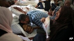 Egyptians mourn over the bodies of their relatives in the El-Iman mosque, Thursday, Aug. 15, 2013.