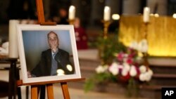 A photo of Father Jacques Hamel is on display during his funeral mass at the Rouen cathedral, Normandy, France, Aug. 2, 2016.