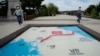 Visitors walk by a map of two Koreas showing North Korea's capital Pyongyang and South Korea's capital Seoul at the Imjingak Pavilion in Paju, near the border with North Korea, South Korea, Sept. 24, 2021.