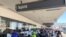 Passengers line up outside the Spirit Airlines terminal at Los Angeles International Airport in Los Angeles on Tuesday, Aug. 3, 2021. Spirit Airlines canceled more than half its schedule Tuesday, and American Airlines struggled to recover from…