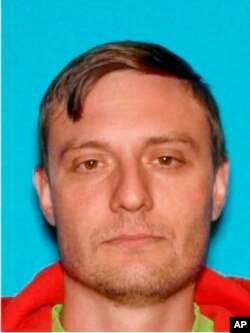 FILE - This undated Department of Motor Vehicles photo provided by the FBI shows Robert Alvin Justus Jr., who has been charged with aiding and abetting the murder and attempted murder of two Federal Protective Services security officers.
