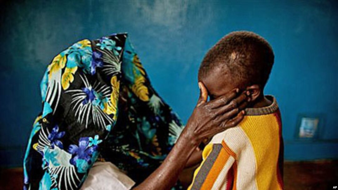 A mass rape victim comforts her son in the town of Fizi, Congo, February 20, 2011