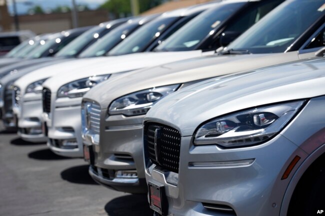 FILE - Unsold 2023 Aviator sports-utility vehicles sit in a long row at a Lincoln dealership on June 18, 2023, in Englewood, Colo. (AP Photo/David Zalubowski, File)