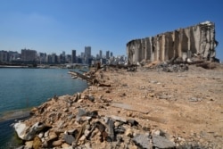 Rubble and debris remain around towering grain silos gutted in the site of a massive deadly explosion in August last year, at the port in Beirut, Lebanon, July 13, 2021.