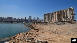 Rubble and debris remain around towering grain silos gutted in the site of a massive deadly explosion in August last year, at the port in Beirut, Lebanon, July 13, 2021. 