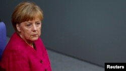 FILE - German Chancellor Angela Merkel during a debate in the lower house of parliament, the Bundestag, in Berlin, Sept. 1, 2014.