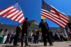 FILE - Anti-lockdown protesters gather outside the Ohio Statehouse in Columbus, Ohio, April 20, 2020.