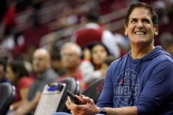FILE - Dallas Mavericks' owner Mark Cuban watches his team warm up before an NBA basketball game against the Houston Rockets, Nov. 24, 2019, in Houston.