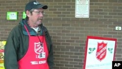 Lanny Green rings a bell to collect money for the Salvation Army outside a grocery store in Arlington, Virginia