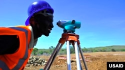 FILE - U.S. aid supports work by the U.S. Agency for International Development. Here, an engineer surveys the site of a power plant being built, with USAID’s help, near Kenya's Lake Baringo. (Courtesy USAID) 