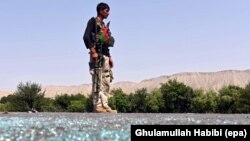 An Afghan soldier keeps watch at a glass-strewn post during clashes with Islamic State militants in the Kot district of Nangarhar province, Afghanistan, June 26 2016. 