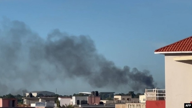 This video grab taken from an AFPTV video on Sept. 17, 2024, shows a plume of smoke rising in Bamako, Mali, as shots and detonations were heard during a jihadist attack on a military airport and training center.