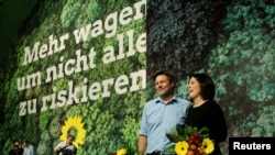 FILE - German Green Party leaders Robert Habeck and Annalena Baerbock are seen after being re-elected during the delegates' conference in Bielefeld, Germany, Nov. 16, 2019.