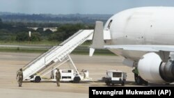 Zimbabwean Armed Soldiers patrol around a United States registered cargo plane at Harare International Airport in Harare, Zimbabwe, Monday, Feb,15.2016.