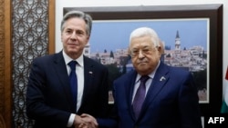 FILE - US Secretary of State Antony Blinken (L) shakeshands with Palestinian president Mahmud Abbas at the Palestinian Muqataa Presidential Compound in the West Bank city of Ramallah on November 5, 2023, amid ongoing battles between Israel and the militant group Hamas.