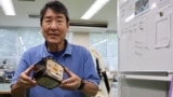 Takao Doi, a former Japanese astronaut and professor at Kyoto University, holds an engineering model of LignoSat during an interview with Reuters at his laboratory at Kyoto University in Kyoto, Japan, October 25, 2024. (REUTERS/Irene Wang)