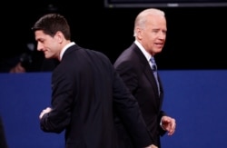 FILE - Vice President Joe Biden (R) and Republican vice presidential nominee Paul Ryan depart at the conclusion of the vice presidential debate in Danville, Kentucky, Oct. 11, 2012.