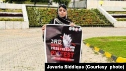 Javeria Siddique holds a banner connected  Press Freedom Day successful  Islamabad, Pakistan. Siddique says she present  speaks up   for everyone. "Because they each  person  the enactment    to beryllium  reunited with their loved ones. I don't person  that option.”