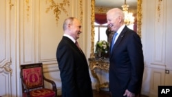 FILE - Russian president Vladimir Putin, left, talks with U.S. president Joe Biden during the U.S. - Russia summit in Geneva, Switzerland, June 16, 2021.