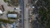 A drone view shows a bulldozer removing debris from a road after Hurricane Milton made landfall, in Matlacha, Florida, Oct. 10, 2024.